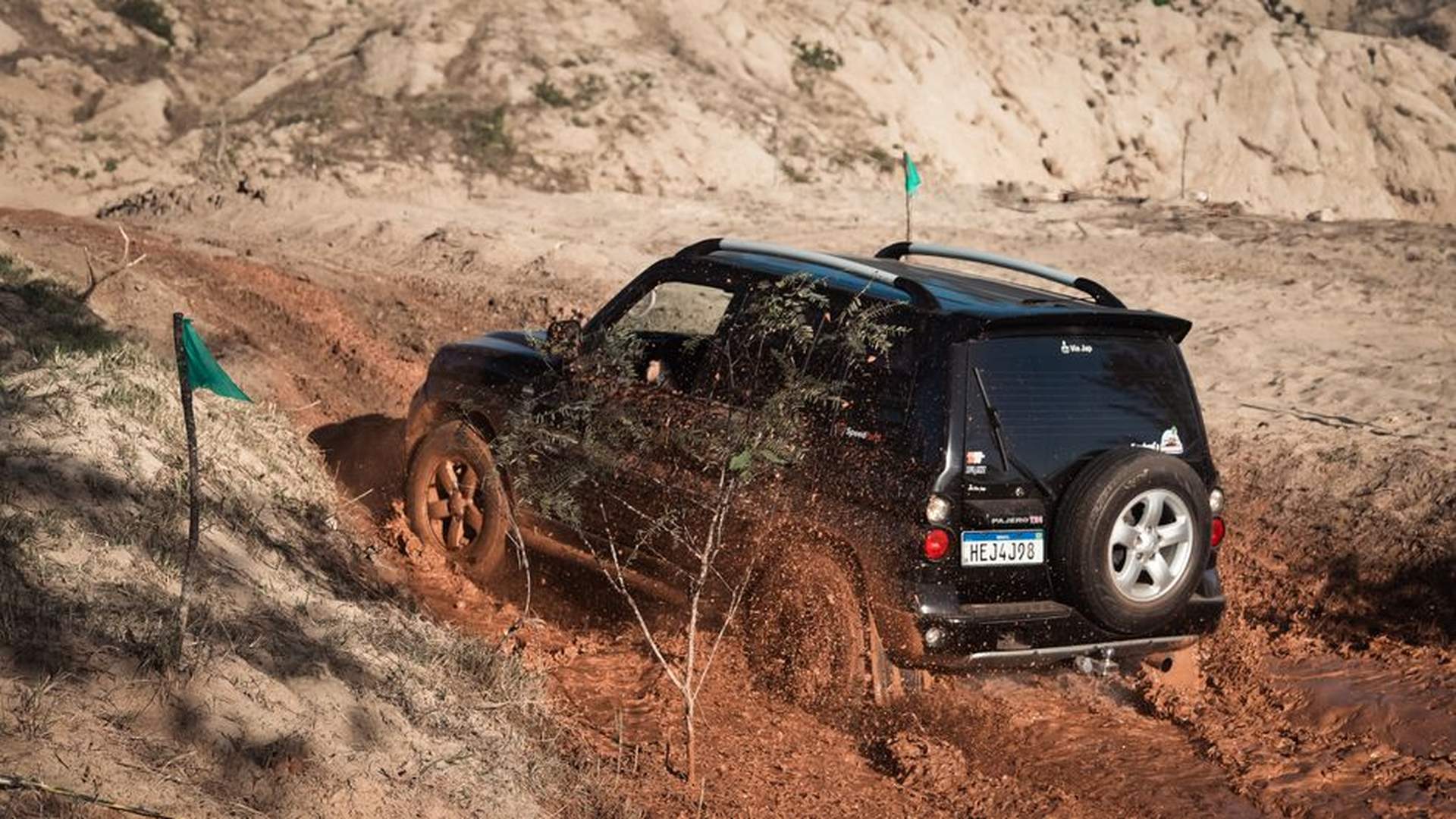 SUV gravel road mountain trail muddy terrain eleva